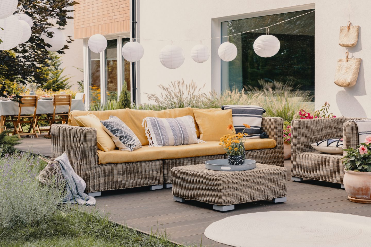 Real photo of a rattan garden furniture set with lamps and table