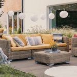 Real photo of a rattan garden furniture set with lamps and table